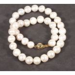A string of cultured freshwater pearls, with a 9ct ball shaped gold clasp, approx 46cm long