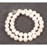 A string of cultured freshwater pearls, of uniform beads with a 9ct ball shaped gold clasp, approx