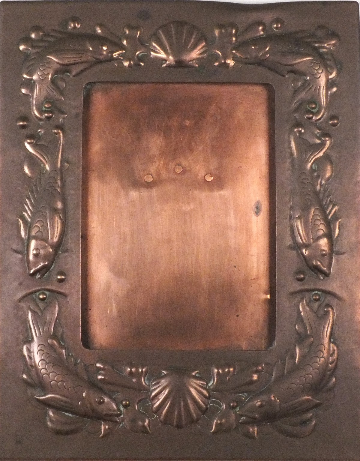 A late 19th/early 20th Century Newlyn copper easel picture frame, rectangular with repousse