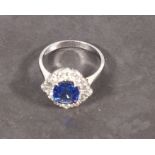 A sapphire and diamond ring, the cushion shaped central stone within diamonds, set in 18ct white