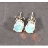 A pair of Ethiopian opal ear studs, claw set in silver