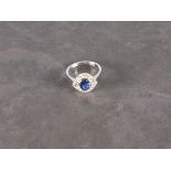 A sapphire and diamond dress ring, the central stone approx. 1.39ct set in 18ct white gold