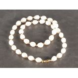 A string of oval shaped freshwater cultured pearls, alternately set with 9ct gold balls with a 9ct