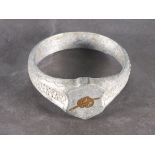 An early 20th Century trench-art napkin ring the aluminium body with punched decoration and