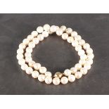 A sting of uniform cultured freshwater pearls, with a 9ct yellow gold ball clasp