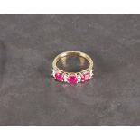 A diamond and ruby ring, the stones claw set in a 9ct yellow gold band,