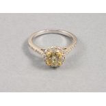 A diamond ring, set in 18ct white gold, the fancy colour stone of yellow tone approx. 1.02ct, set