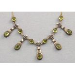 A peridot fringe necklace, set with diamonds on a fine gold chain, boxed