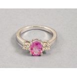 A pink sapphire and diamond three stone ring, claw set in 18ct white gold, central stone 1.5ct