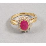 A ruby and diamond cluster ring, set in 9ct yellow gold, the central ruby approx. 1.161ct