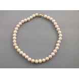 A string of freshwater cultured pearls, set with a 9ct gold ball clasp, 45cm long