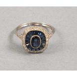An Art Deco style sapphire and diamond dress ring, set in platinum, the oval cut central stone set