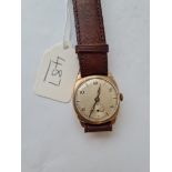 A gents wrist watch with seconds dial in 9ct with brown leather strap