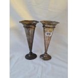 A good pair of Edwardian oval spill vases, the fronts embossed with vases of flowers - 8" high -