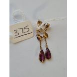 A pair of garnet drop earrings in 9ct