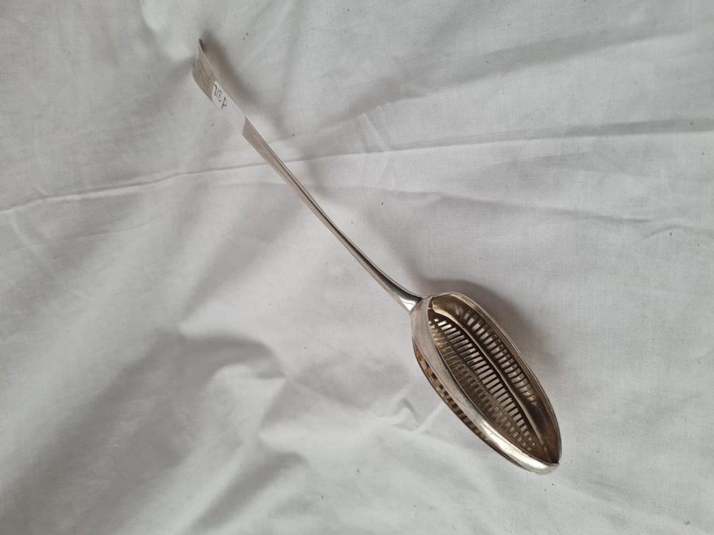 A continental straining spoon with crested end