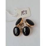A pair of gold mounted onyx cufflinks