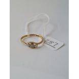 A three stone diamond ring in 18ct gold - size R1/2 - 2gms