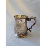 A George II pint tankard, the body engraved with scrolls - leaf capped handle - 5" high - London