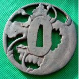 A carved TSUBA - TETSA