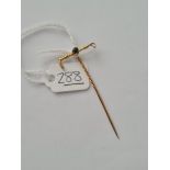 A riding crop pin with sapphire set in gold