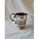 A embossed christening mug with leaf-capped handle - 3.5" high - B'ham 1907 - 111gms