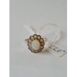 An attractive opal cluster ring in 9ct with good central opal & 12 surrounding opals