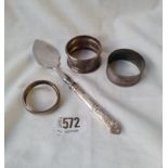 Three various napkin rings and a mounted jam spoon