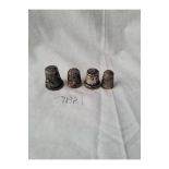 Four various silver thimbles