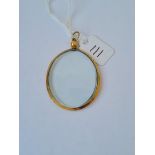 An oval double sided glass locket in 9ct mount