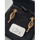A pair of drop earrings set with small garnets in 9ct - boxed -