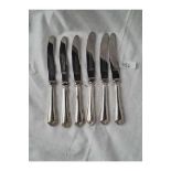 A set of six silver handled tea knives with steel blades