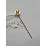 A diamond topped stick pin in 15ct gold