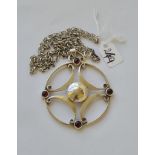 A large silver and garnet pendant and chain