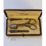 A boxed four-piece sewing set