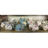 SHELF OF CHINAWARE INCL; 3 DIFFERENT PATTERNED TEA SETS - CUPS, SAUCERS & DISHES