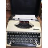 OLYMPIA CASED PORTABLE TYPEWRITER WITH METAL COVER