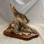 PLASTER MODEL OF A HOWLING WOLF ON ROCKS WITH WOODEN PLINTH CALLED ''CALL OF THE WILD'' BY BALL FINE