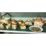 SHELF OF COTTAGE POTTERY CONSISTING OF BUTTER DISH & COVERS, TEA POTS ETC