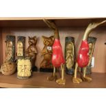 SHELF OF WOODEN ORNAMENTS, 2 CATS FROM INDONESIA, 3 CARVED FACES FROM BALI, A GREEN MAN & 2 DUCKS