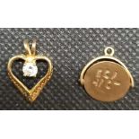 A 9ct SPINNING FOB & A MOUNTED HEART SHAPED PENDANT