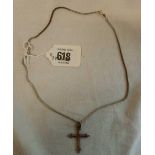 A SILVER CROSS ON A SILVER NECK CHAIN