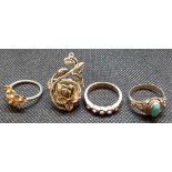 FOUR SILVER STONE SET RINGS