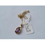 An amethyst pendant in 9ct