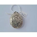 A silver chased oval locket