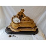 A decorative 19th Century French mantle clock adorned with a classical lady - 19" long on wooden