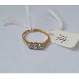 A small three stone diamond ring in 18ct gold size K