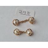 A pair of unmarked gold & pearl cufflinks