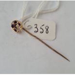 An Edwardian gold top stick pin unmarked and set with a pearl