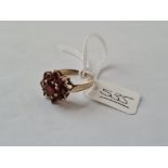 A garnet cluster ring set in gold - size O - 2/8gms